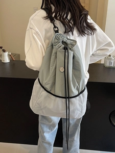 Blue and white nylon drawstring backpack with mesh panel and metallic buckle detail