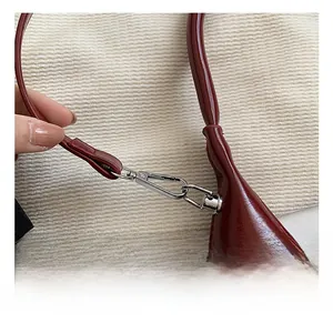 Detailed macro view of premium silver lobster clasp and glossy burgundy leather strap