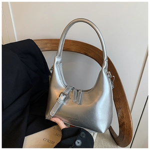 Close-up of silver metallic hobo bag with fashion decorative buckle and embossed text