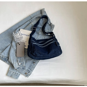 Deep blue denim crossbody bag with multi-zipper pockets and adjustable strap for women