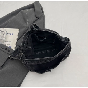 Top view of the interior compartment with pockets of a gray wash denim tote bag