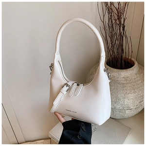 Detail of white moon hobo bag featuring fine leather texture and fashion logo lettering