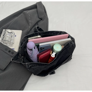 Spacious washed denim tote bag showing interior storage with tablet, umbrella and wallet