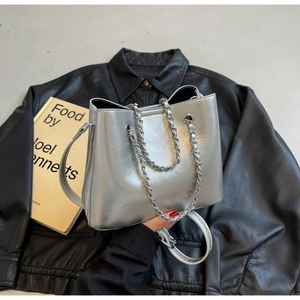Top view of metallic silver bucket bag with chain handles and adjustable strap