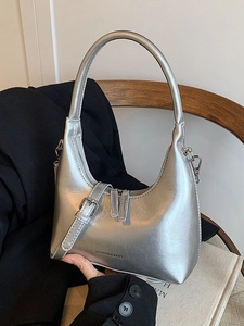Chic silver crescent underarm handbag with metallic finish and side buckle detail