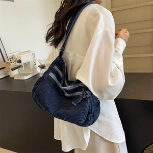 Deep blue denim crossbody tote bag with multi-zipper pockets for a casual street style