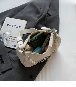 Close-up of white leather bag interior showing spacious compartments for daily items