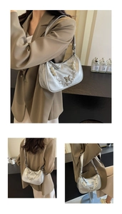 Silver underarm bag with butterfly metal charm and pearl chain strap detail