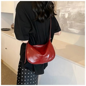 Detailansicht der roten Halbmond-Schultertasche mit Reißverschluss zum Outfit