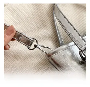 Close-up of premium silver metal hook and double-stitched strap on the bucket bag