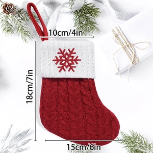 Red and white knit Christmas stocking with snowflake embroidery and holiday decor