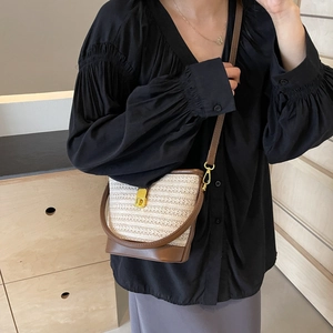 Handcrafted rainbow woven bucket bag with brown leather trim and golden metal lock