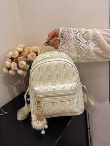 Cream mini backpack with cartoon bear print and plush charm for casual travel