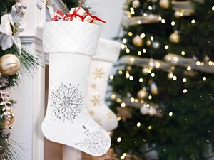 Close-up of white leather Christmas stockings with silver sequined snowflake details