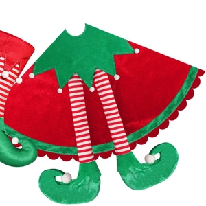 Christmas tree skirt with red velvet fabric and festive elf legs with striped stockings