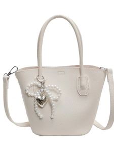 Chic beige lychee textured bucket bag with pearl bow and silver heart charm