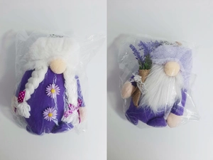 Detail of plush lavender gnomes featuring white beard, braids and floral decorations