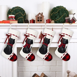 Detailed view of four Christmas stockings with black cat and dog silhouettes and plaid bows