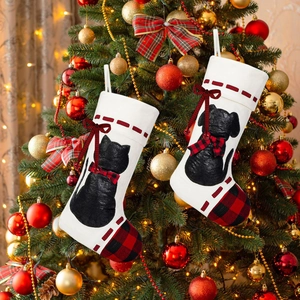 Detail of Christmas stockings with black cat and dog silhouettes on a decorated tree