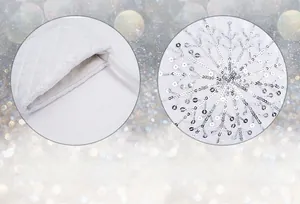 Detail of white Christmas stocking showing large opening and silver sequin snowflake pattern