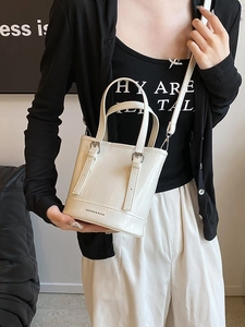 Fashionable cream bucket bag with top handles and adjustable strap for women