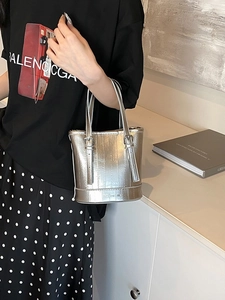 Silver metallic bucket bag with vertical embossed stripes and top handle for women