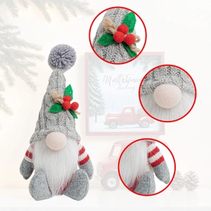 Detail of a Christmas gnome with grey knit hat, white beard, and holly berries decoration
