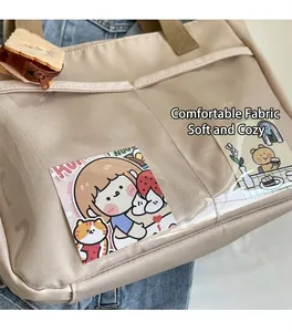 Detail of beige nylon tote bag with clear PVC pocket, illustration, and toast charm
