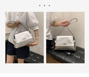 Detailed close-up of metallic silver shoulder bag with chain strap and brushed texture