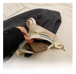 Detail showing the inner capacity of the striped woven crossbody bag with daily essentials