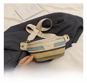 Detail of hand-woven crossbody chest bag with colorful stripes and beige faux leather