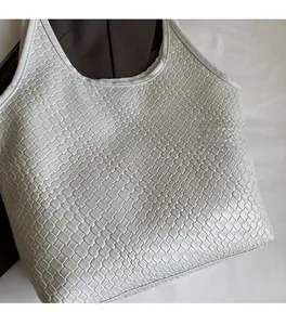 Detailed view of the intricate white woven texture and soft vegan leather craftsmanship