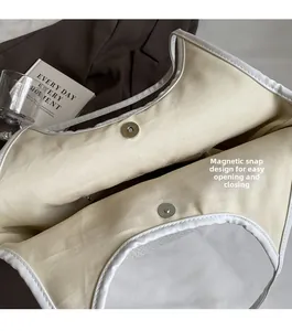 Close-up of the magnetic snap closure on a high-capacity minimalist canvas tote bag