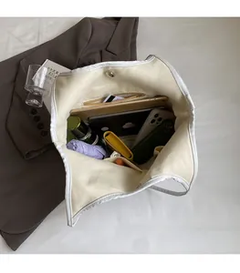Top-down view of spacious white canvas tote bag interior showing large storage capacity
