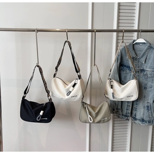 Detail showing various colors of the minimalist dumpling bags with stylish wide straps
