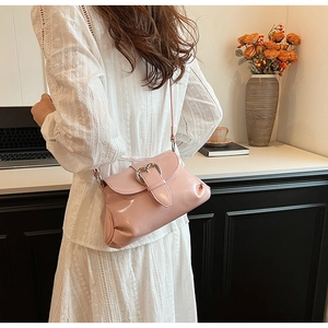 Detail of pink saddle bag with silver heart buckle and stylish side pleated texture