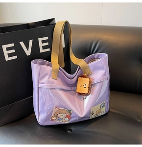 Detail of lavender nylon tote with transparent PVC pocket and cartoon card inserts