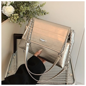 Detail of silver metallic tote with striped texture and elegant chain shoulder strap