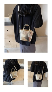 Detailed view of mini metallic gold bucket bag with fashion lettering and puppy charm