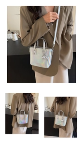Detail view of silver holographic bucket bag with metallic balloon dog charm
