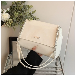 Detail of striped embossed beige shoulder bag with silver logo and chain leather strap