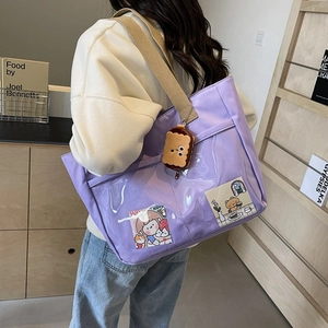 Purple nylon tote bag with transparent PVC pocket and cute plush charm on shoulder