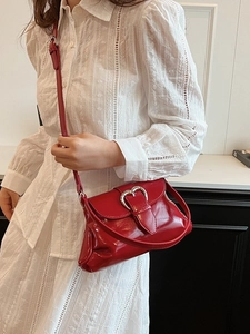 Glossy red faux leather shoulder bag with a silver heart-shaped clasp for women