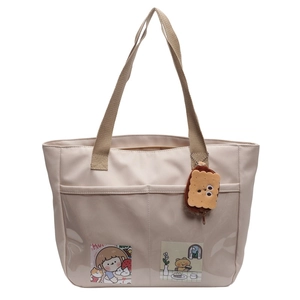 Large beige nylon tote bag with transparent PVC pocket and brown straps on white background