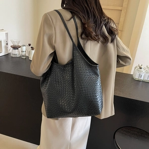 Black woven large capacity tote bag with dual shoulder straps for daily commuting