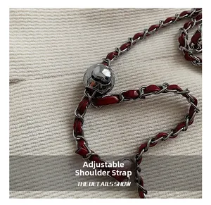 Close-up of red leather interwoven silver chain strap with spherical metal adjuster