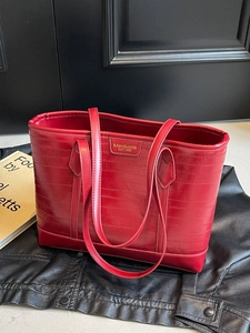 Large red textured leather tote bag for women with shoulder straps and brand logo