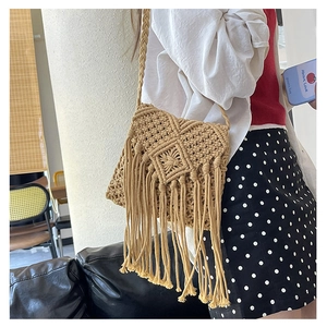 Macro detail of hand-woven bohemian crossbody bag with intricate fringe and tassels