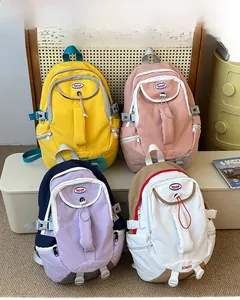 Detailed display of high-capacity nylon student backpacks in yellow, pink, and mixed colors