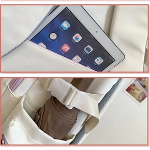 Detail view of large capacity backpack interior holding iPad and umbrella with purple zippers